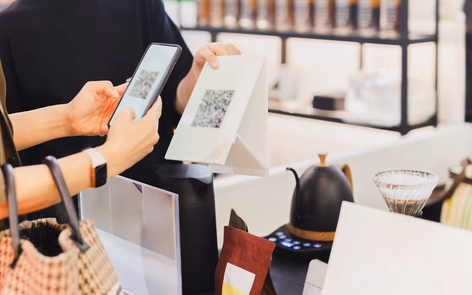 Customer scanning QR code in store to join digital loyalty program.